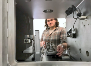 Dr. Glen Smales placing the hexapod in the sample chamber.