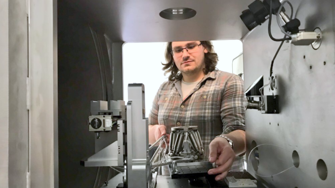 Dr. Glen Smales placing the hexapod in the sample chamber.