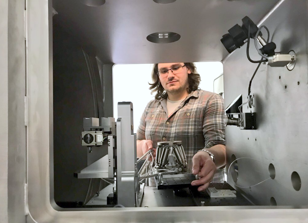 Dr. Glen Smales placing the hexapod in the sample chamber.