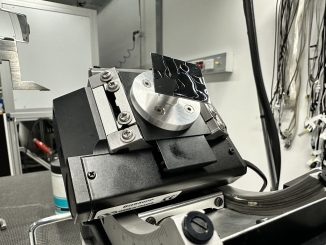 A scrap wafer mounted on our GI sample holder, held on with grease. The sample is tilted at the maximum angle to investigate stability.